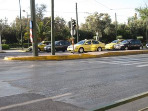 Crossing the street near the Temple of Olympian Zeus required going around a big curb!  The taxis shown in this pic are typical of the normal (non-accessible) taxis.