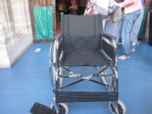 Everyone walking will have to take off their shoes to enter. Wheelchair users will have to transfer to this wheelchair.