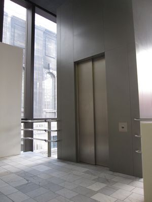 After pressing a button to open the door to the museum, an elevator will take you up to the reception desk.