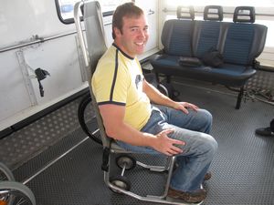 Me in an aisle chair.  At many European airports they will get you off the plane using a lift vehicle.  This is me on the aisle chair waiting to get taken into the plane, down the aisle, to my seat.