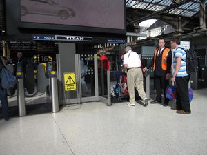 Some train stations have controlled access to the platforms.  At one end there will be a larger pathway for strollers, whelchairs, and bicycles.