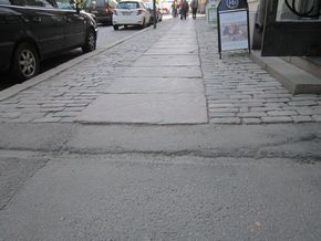 Smooth Granite Slabs Covering The Uneven Cobblestones